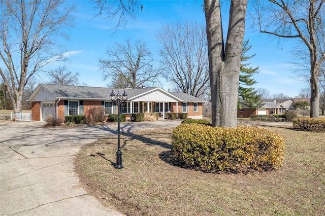 ranch-style house featuring brick siding, concrete driveway, and a garage