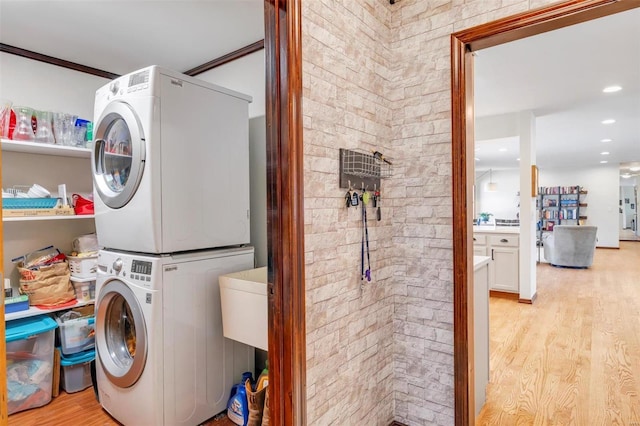 washroom featuring recessed lighting, light wood-style floors, laundry area, and stacked washer / dryer