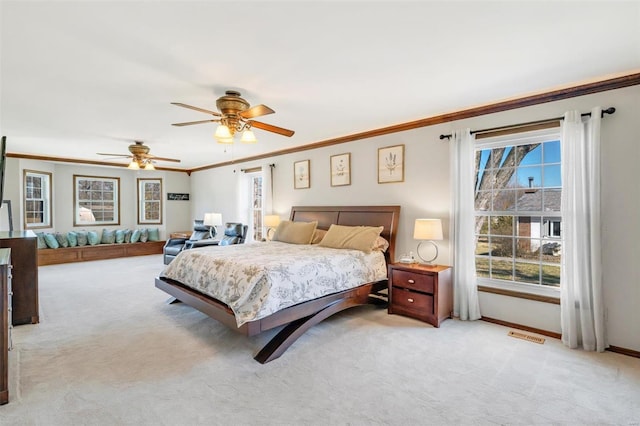 bedroom featuring crown molding, light colored carpet, baseboards, and ceiling fan