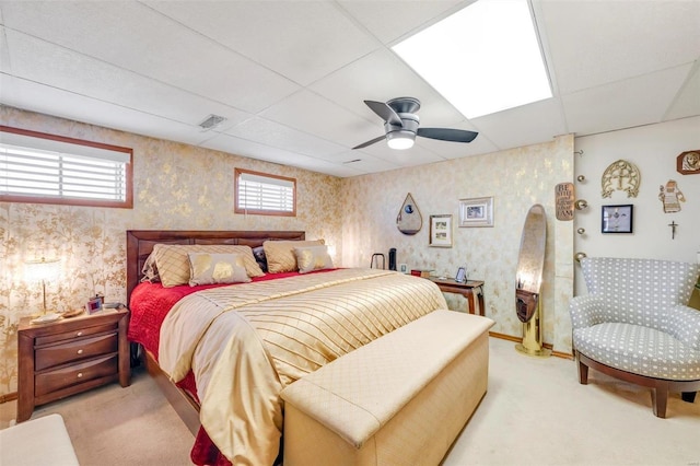 bedroom featuring wallpapered walls and multiple windows