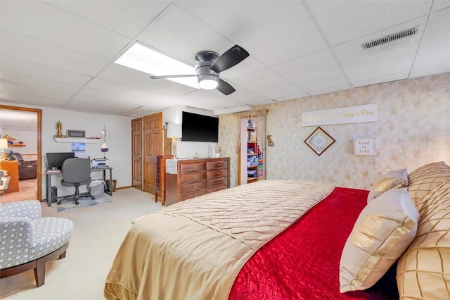 carpeted bedroom with visible vents, baseboards, a paneled ceiling, and a ceiling fan