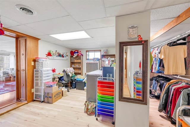 interior space featuring a drop ceiling, visible vents, and wood finished floors