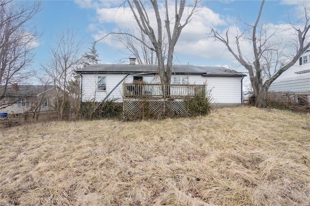 back of property featuring a deck and a chimney