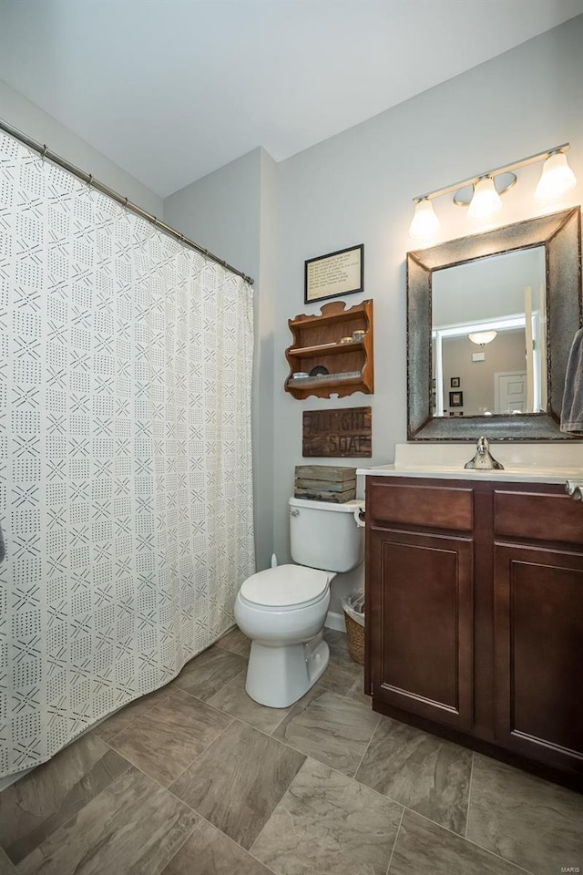 full bath with toilet and vanity