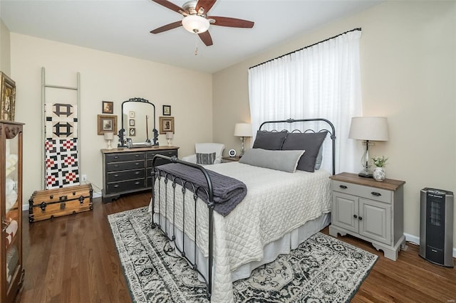 bedroom with dark wood-style floors, baseboards, and ceiling fan