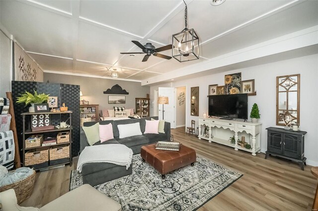 living area featuring ceiling fan, baseboards, coffered ceiling, and wood finished floors