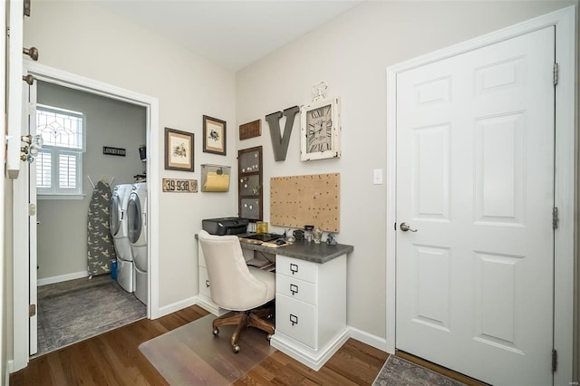 office area featuring baseboards, dark wood-style floors, and washer and clothes dryer