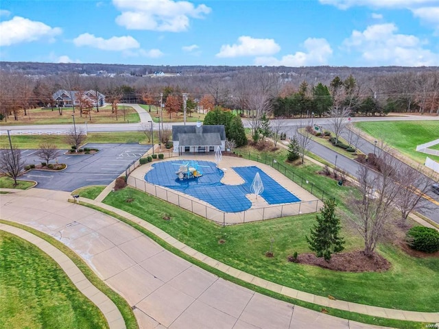 view of pool featuring a fenced in pool, a lawn, and fence