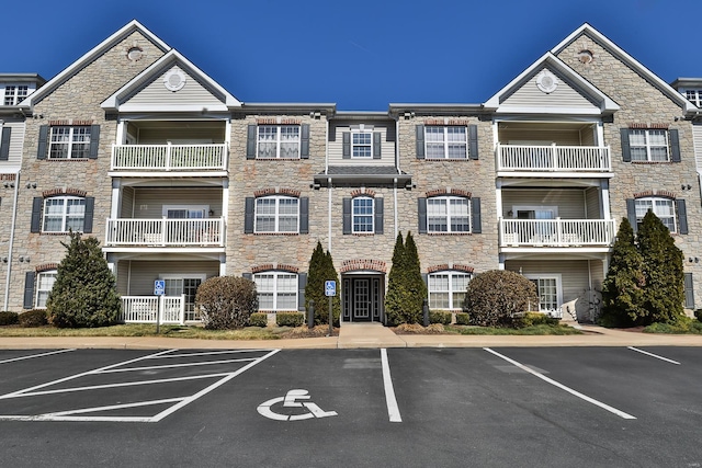 view of property featuring uncovered parking