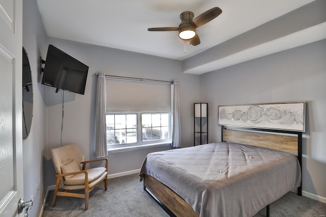 carpeted bedroom with ceiling fan and baseboards