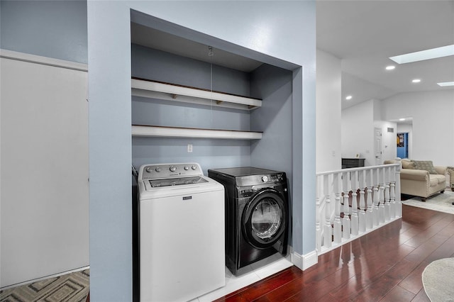 laundry area featuring washer and clothes dryer, wood finished floors, recessed lighting, a skylight, and laundry area