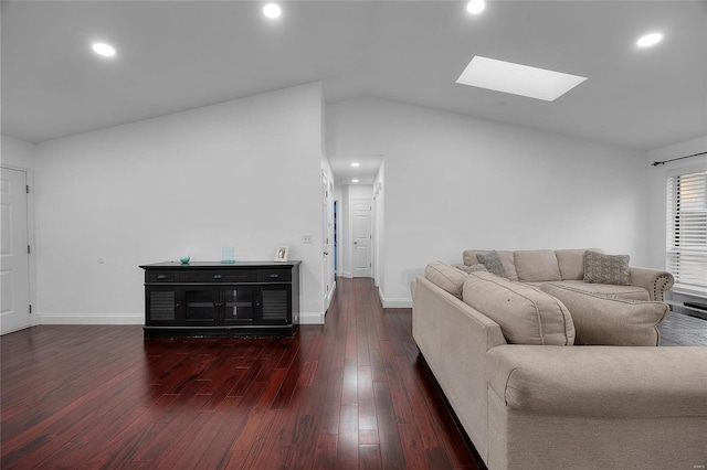 living room featuring lofted ceiling with skylight, recessed lighting, baseboards, and hardwood / wood-style floors