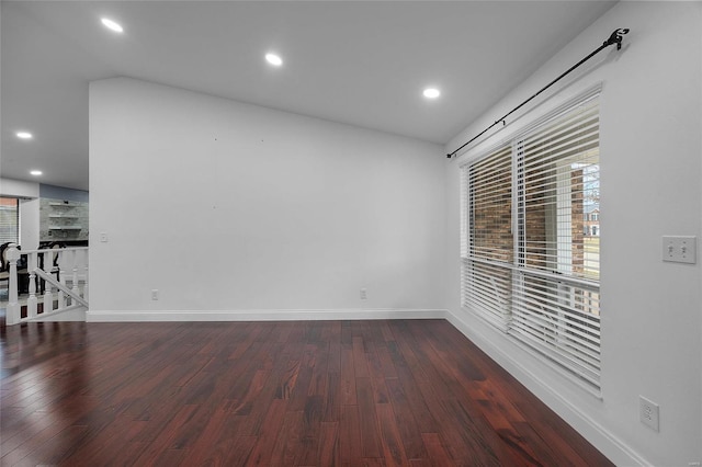 spare room featuring recessed lighting, baseboards, and wood finished floors