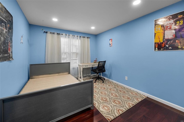 bedroom with recessed lighting, wood finished floors, and baseboards