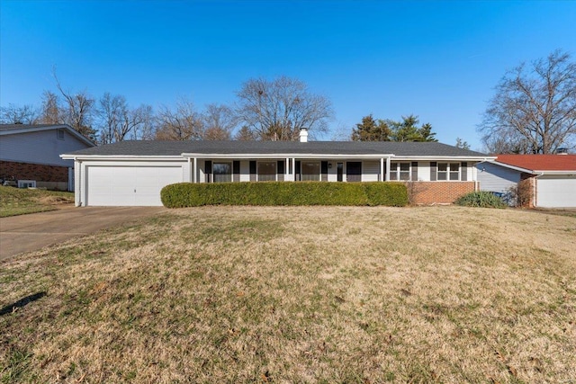 ranch-style house with brick siding, driveway, a front yard, and a garage