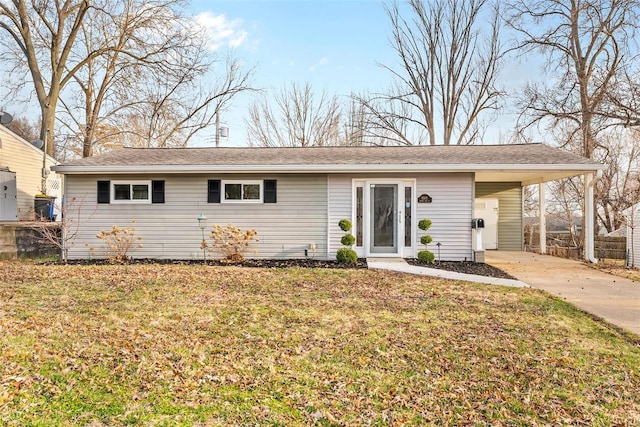 ranch-style home featuring a carport, driveway, and a front lawn