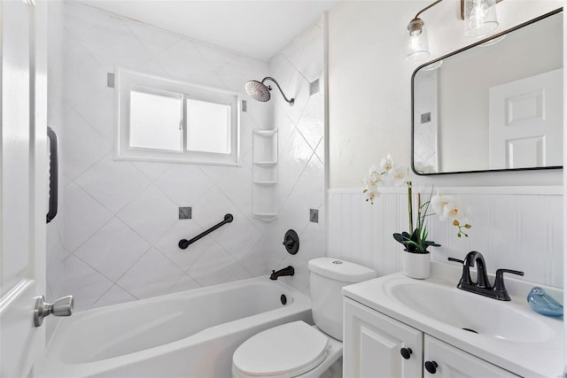 full bath with a wainscoted wall, toilet, vanity, and shower / tub combination