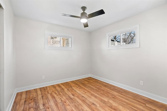 empty room featuring baseboards, light wood-style floors, and a ceiling fan