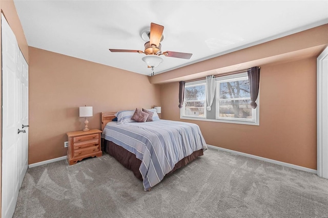 carpeted bedroom featuring baseboards and ceiling fan