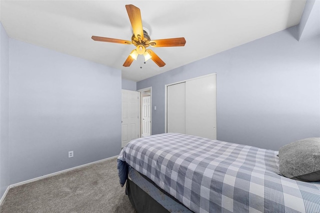 carpeted bedroom featuring a closet, baseboards, and ceiling fan