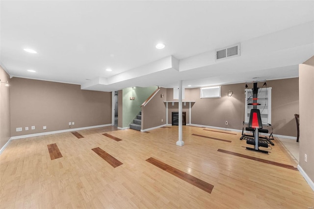 workout area featuring visible vents, recessed lighting, baseboards, and wood finished floors