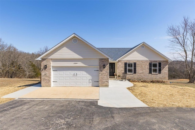 ranch-style home with concrete driveway, an attached garage, and brick siding