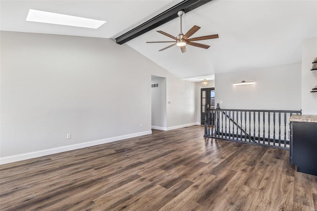 unfurnished room featuring visible vents, ceiling fan, baseboards, lofted ceiling with skylight, and wood finished floors