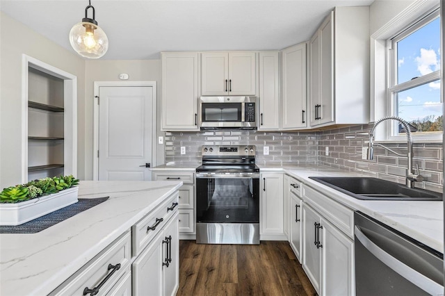 kitchen featuring a sink, stainless steel appliances, white cabinets, and dark wood finished floors