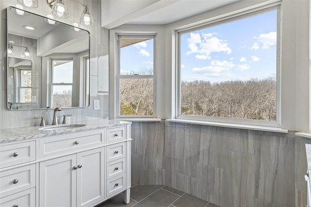 bathroom featuring tile walls, vanity, and tile patterned flooring