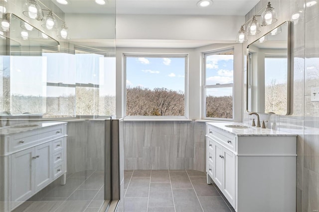 bathroom with recessed lighting, tile walls, vanity, and tile patterned flooring