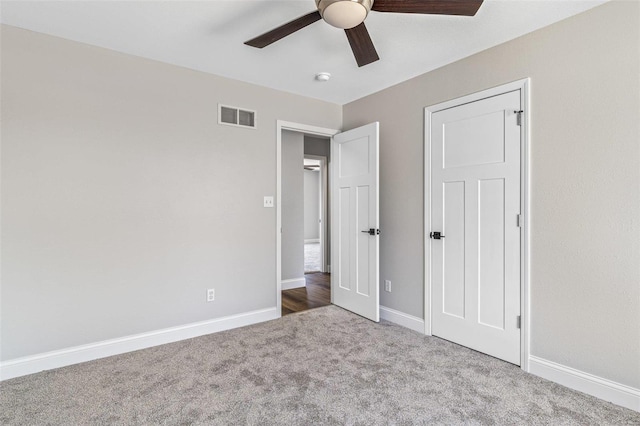 unfurnished bedroom featuring carpet flooring, baseboards, and visible vents