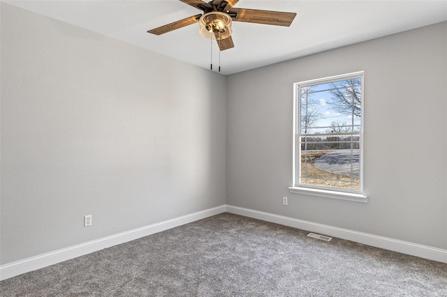 carpeted empty room featuring visible vents, ceiling fan, and baseboards