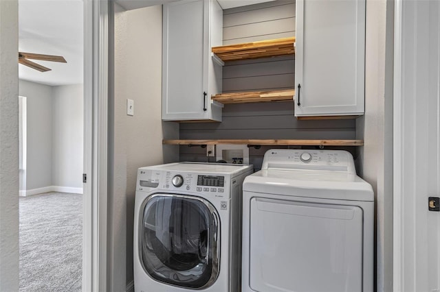 clothes washing area with a ceiling fan, baseboards, carpet floors, cabinet space, and washing machine and dryer