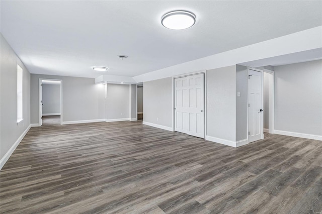 finished basement featuring baseboards and dark wood-style flooring