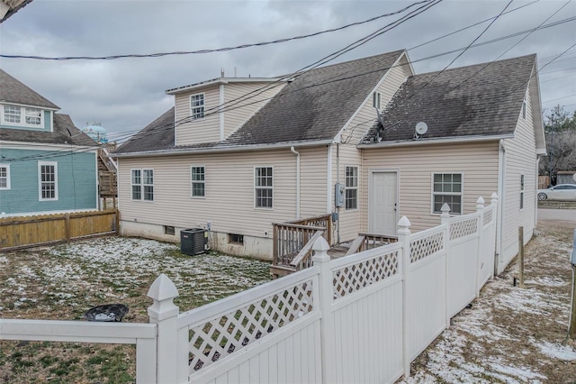 back of house with a wooden deck, fence private yard, central AC, and a shingled roof