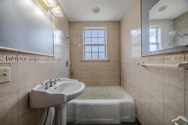 full bath featuring tile walls and  shower combination