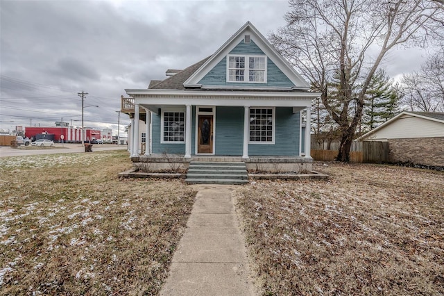 view of front of home with fence and covered porch