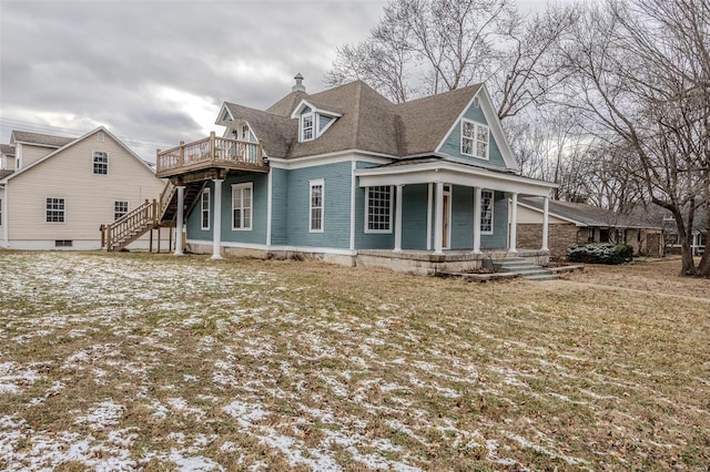 view of front of house with stairway, a chimney, and a shingled roof