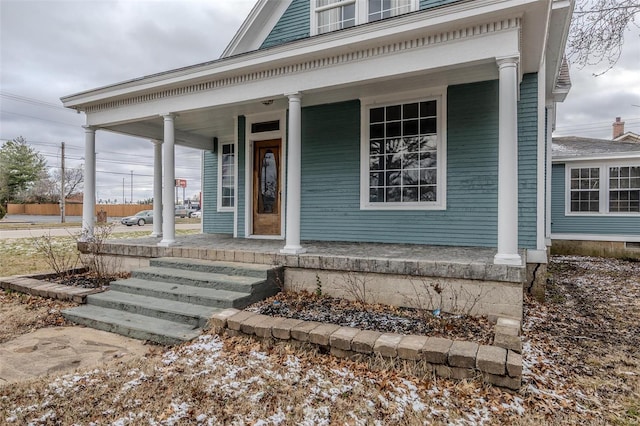 view of exterior entry with covered porch