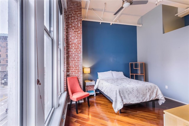 bedroom with ceiling fan and wood finished floors