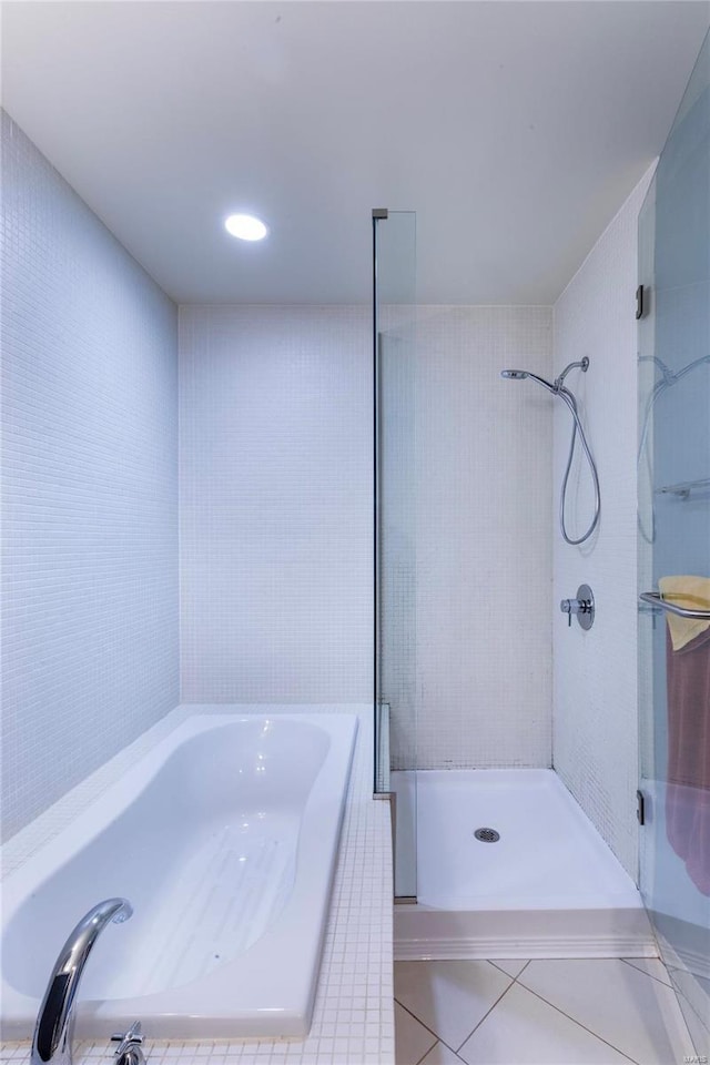 full bath featuring tile patterned floors, a shower stall, and a garden tub