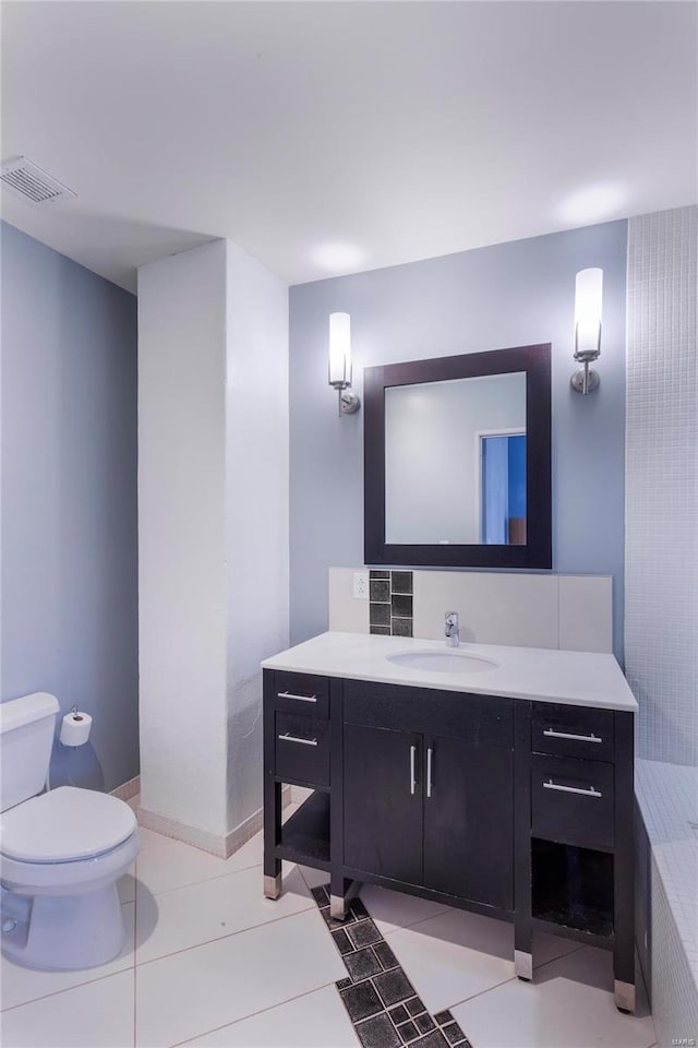 bathroom with visible vents, toilet, vanity, and tile patterned flooring