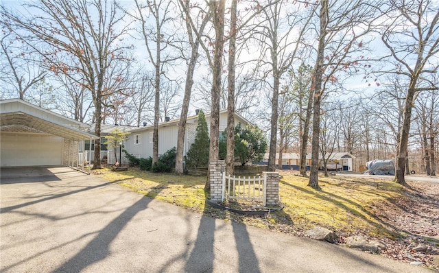 view of front facade with an attached garage, brick siding, and driveway