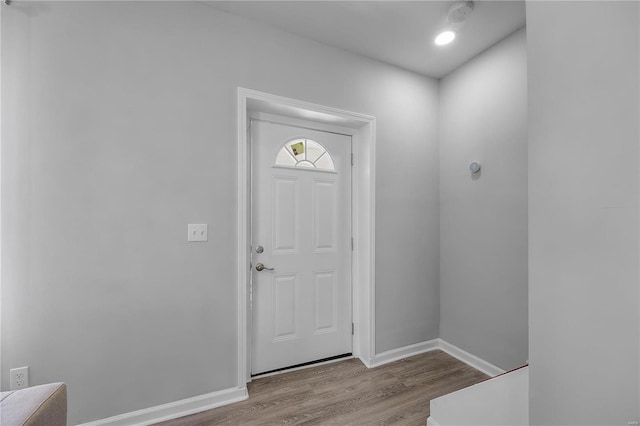 entryway featuring baseboards and wood finished floors