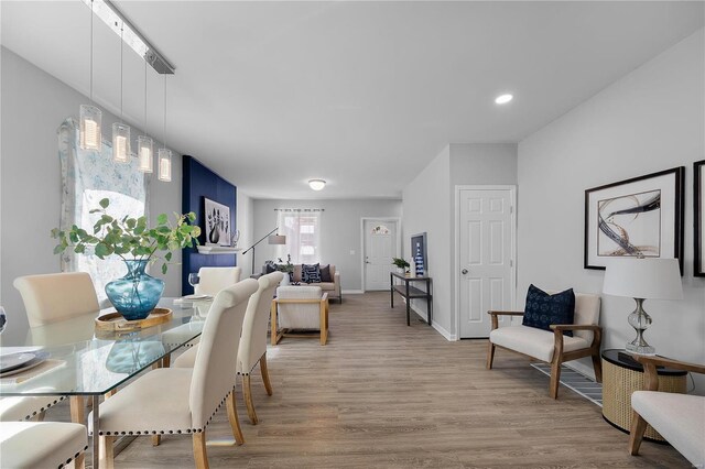 dining space featuring wood finished floors and baseboards