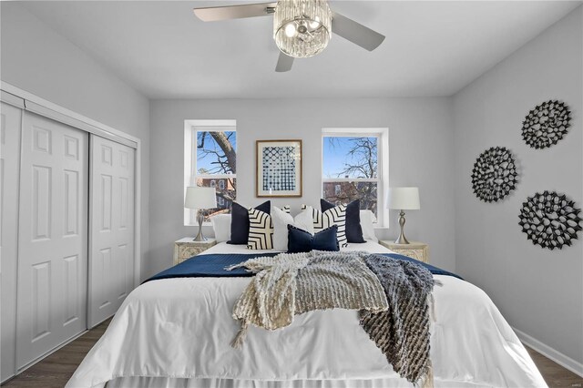 bedroom featuring baseboards, wood finished floors, a closet, and ceiling fan