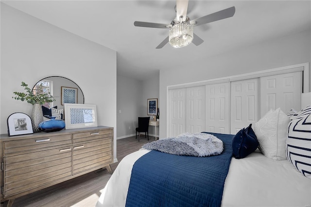 bedroom with a ceiling fan, visible vents, baseboards, dark wood finished floors, and a closet