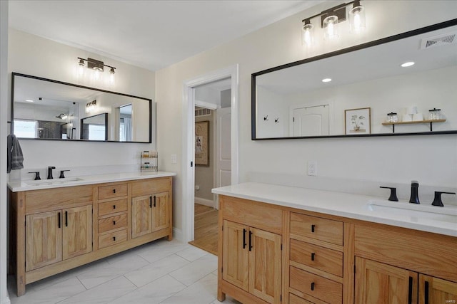 bathroom with vanity, toilet, and visible vents