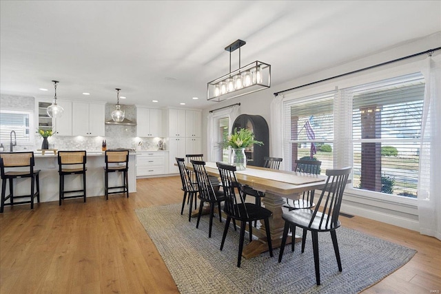 dining room featuring recessed lighting, light wood-style flooring, and baseboards