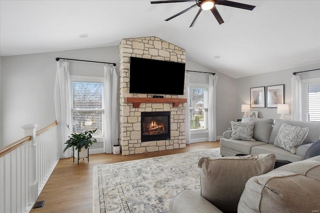 living room featuring a wealth of natural light, visible vents, and a ceiling fan